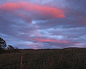 Zonsondergang met regenboog